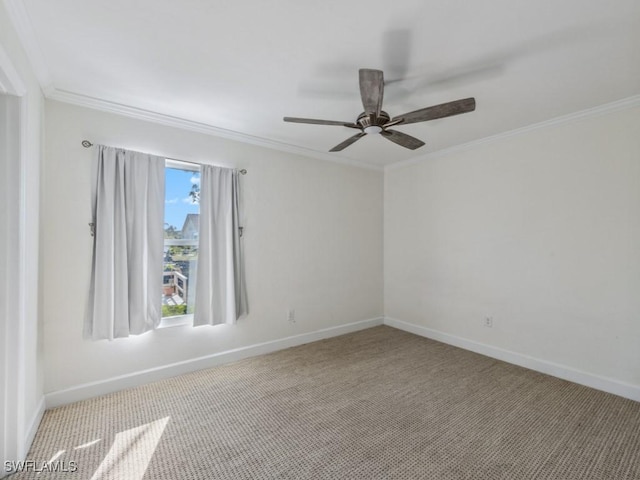 unfurnished room featuring ornamental molding, a ceiling fan, baseboards, and carpet floors