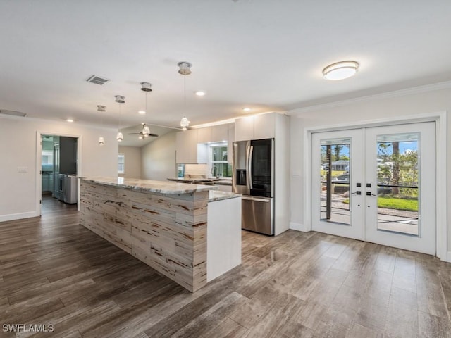 kitchen featuring dark wood-style floors, stainless steel fridge, french doors, and a kitchen island