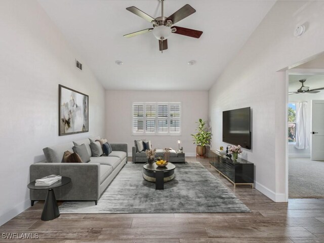 living area featuring plenty of natural light, lofted ceiling, and a ceiling fan