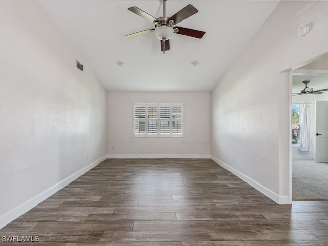 spare room with a wealth of natural light, visible vents, lofted ceiling, and ceiling fan