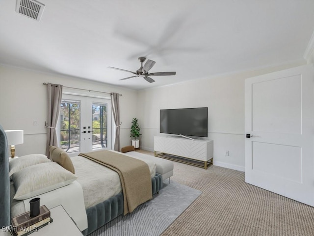 carpeted bedroom featuring baseboards, visible vents, ornamental molding, access to exterior, and french doors