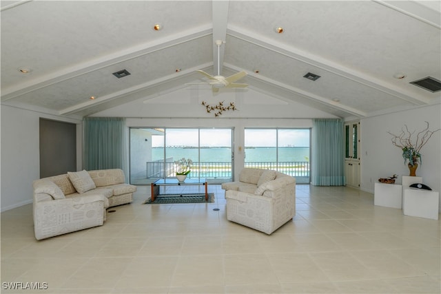 living room with a water view, vaulted ceiling with beams, plenty of natural light, and visible vents