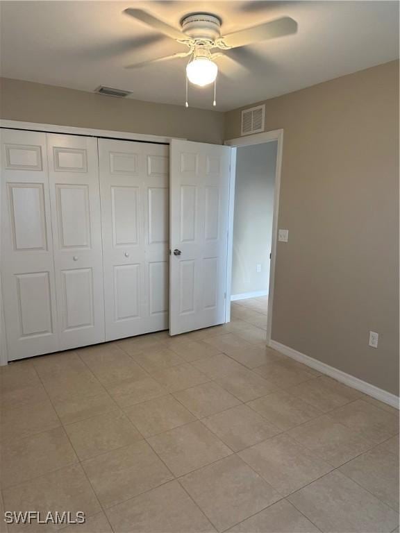 unfurnished bedroom with a ceiling fan, baseboards, visible vents, and a closet