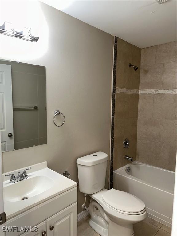 full bathroom featuring shower / bath combination, toilet, vanity, and tile patterned flooring