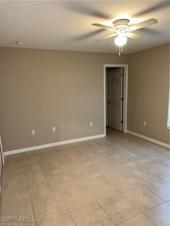 spare room featuring baseboards and a ceiling fan