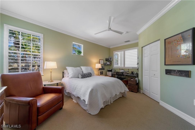 bedroom featuring light carpet, baseboards, a ceiling fan, crown molding, and a closet