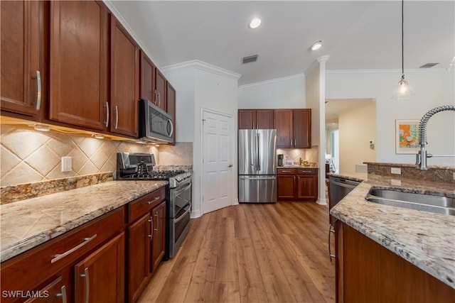 kitchen featuring appliances with stainless steel finishes, light stone countertops, visible vents, and pendant lighting