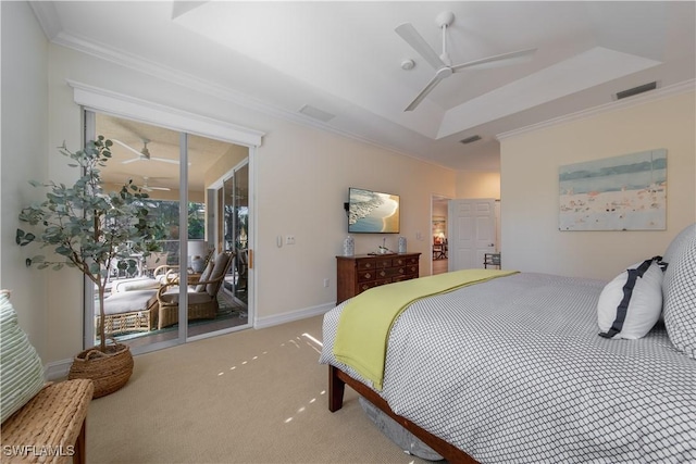 carpeted bedroom with access to exterior, a tray ceiling, visible vents, and ornamental molding