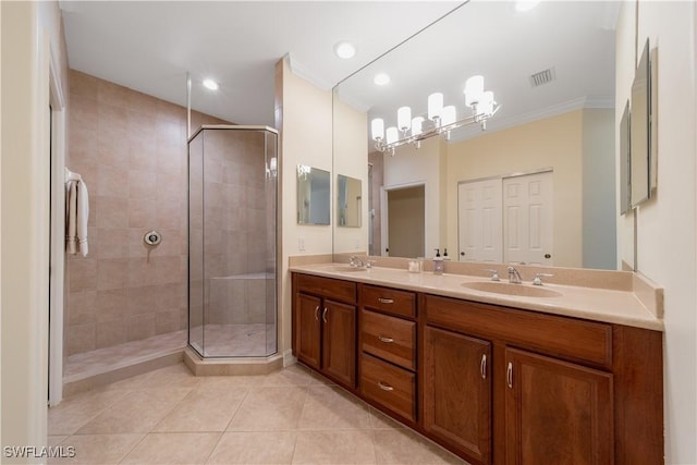 bathroom featuring double vanity, visible vents, a stall shower, a sink, and tile patterned flooring