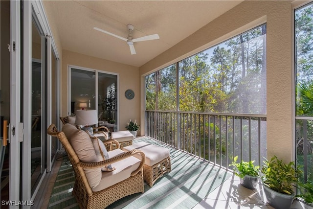 sunroom / solarium featuring ceiling fan