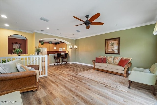 living room featuring baseboards, ceiling fan, wood finished floors, crown molding, and recessed lighting