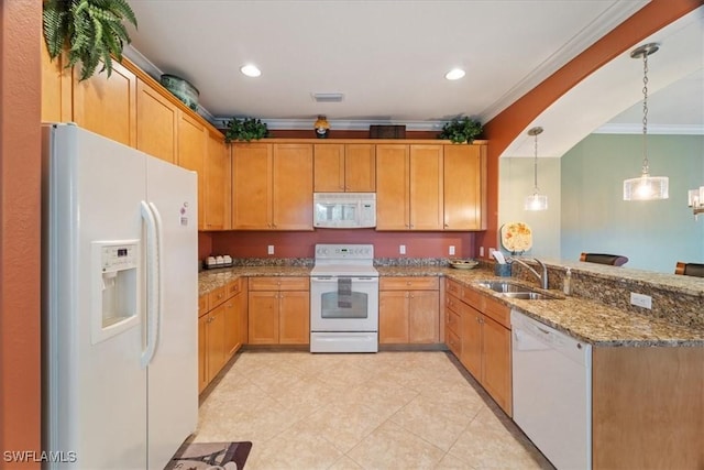 kitchen featuring a peninsula, white appliances, a sink, hanging light fixtures, and crown molding