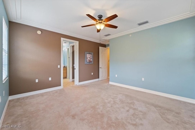 unfurnished room with light carpet, baseboards, visible vents, ceiling fan, and ornamental molding