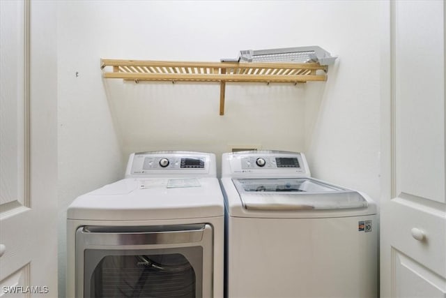 laundry area with laundry area and independent washer and dryer