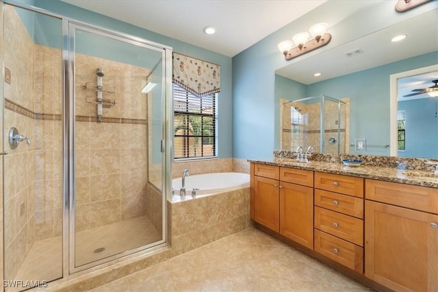 bathroom with double vanity, a shower stall, a bath, and tile patterned floors