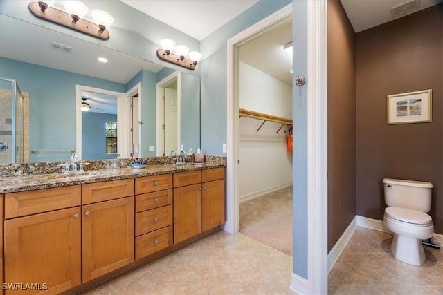 full bath with double vanity, visible vents, toilet, a sink, and tile patterned floors