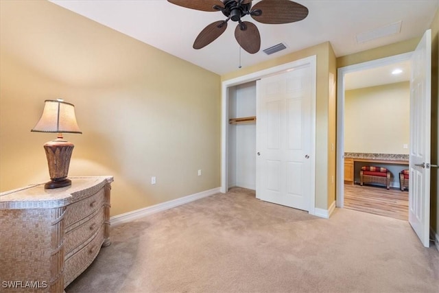 unfurnished bedroom with ceiling fan, light carpet, visible vents, baseboards, and a closet