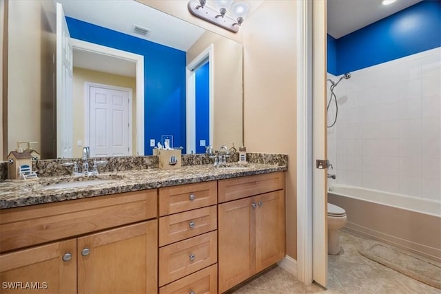 full bath with double vanity, bathing tub / shower combination, a sink, and toilet