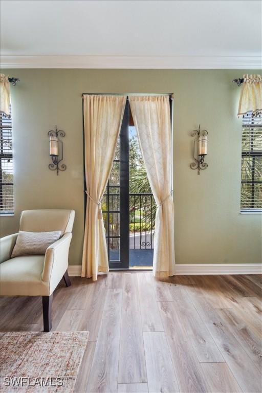 doorway to outside with light wood-style floors and baseboards