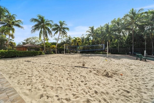 view of community with volleyball court and fence