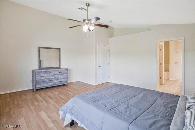 bedroom with lofted ceiling, visible vents, baseboards, and wood finished floors