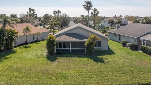 back of property with a yard and a residential view