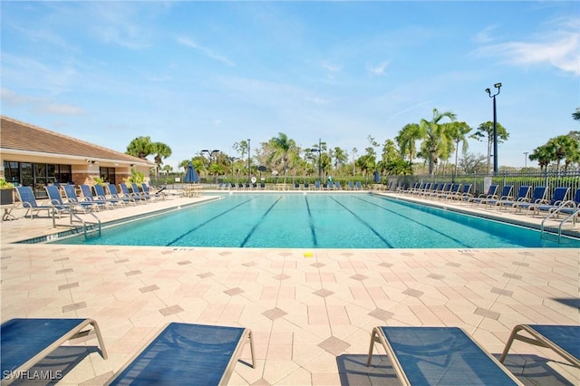 pool featuring a patio and fence