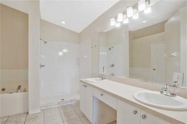 full bath with a bath, tile patterned flooring, a sink, and tiled shower