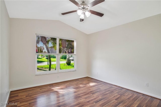 empty room with lofted ceiling, ceiling fan, baseboards, and wood finished floors