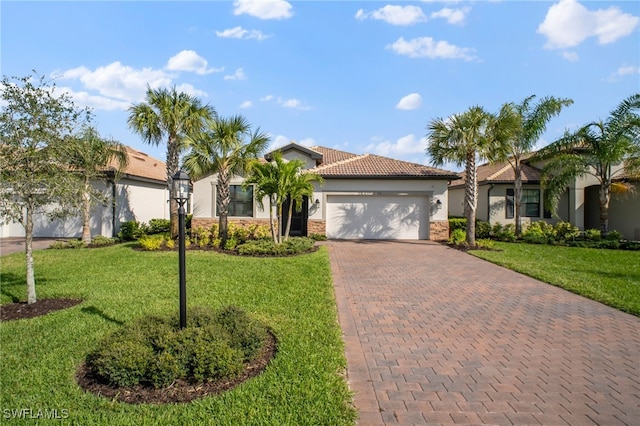 view of front of property with an attached garage, stone siding, decorative driveway, stucco siding, and a front yard