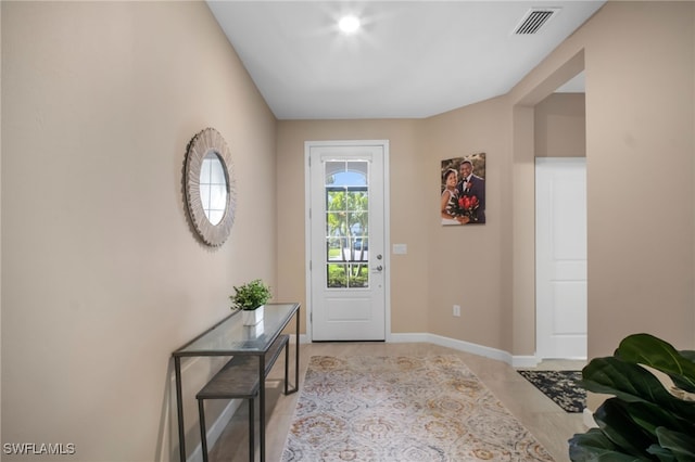 doorway to outside with visible vents and baseboards