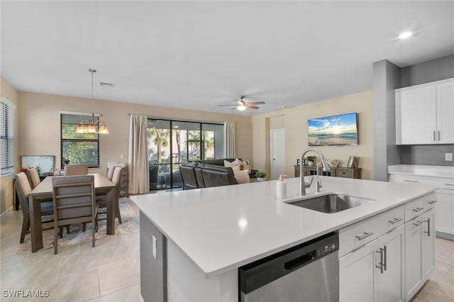 kitchen with light countertops, a kitchen island with sink, a sink, white cabinetry, and dishwasher