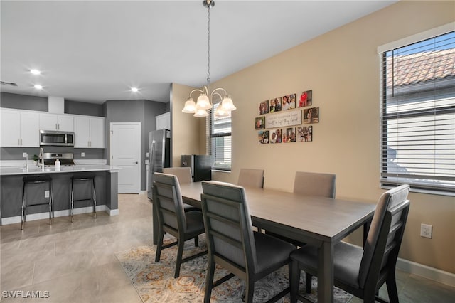 dining room featuring baseboards, recessed lighting, visible vents, and a notable chandelier