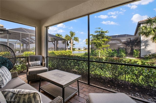 sunroom / solarium featuring a water view