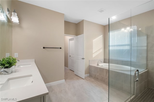 full bathroom with a stall shower, a garden tub, a sink, and baseboards