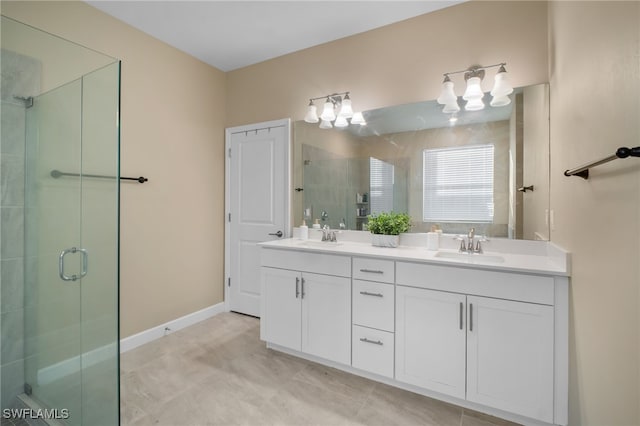 full bathroom with a stall shower, a sink, baseboards, and double vanity