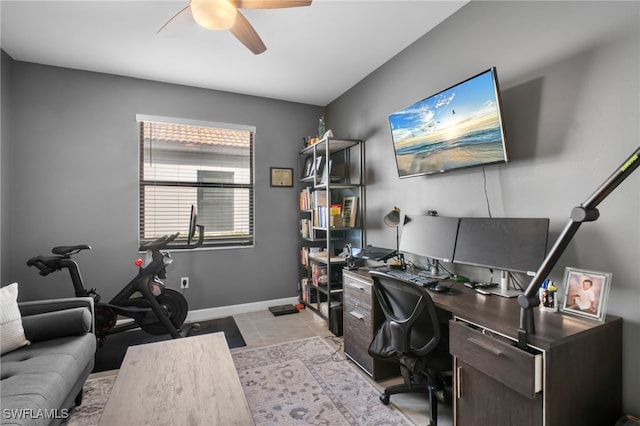 home office with light tile patterned floors, baseboards, and a ceiling fan