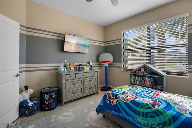 bedroom featuring a ceiling fan and light tile patterned flooring