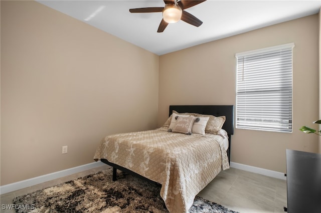 bedroom with tile patterned flooring, ceiling fan, and baseboards