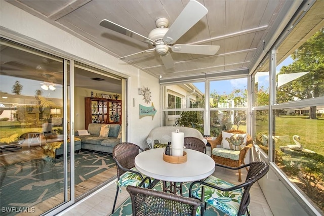 sunroom featuring ceiling fan