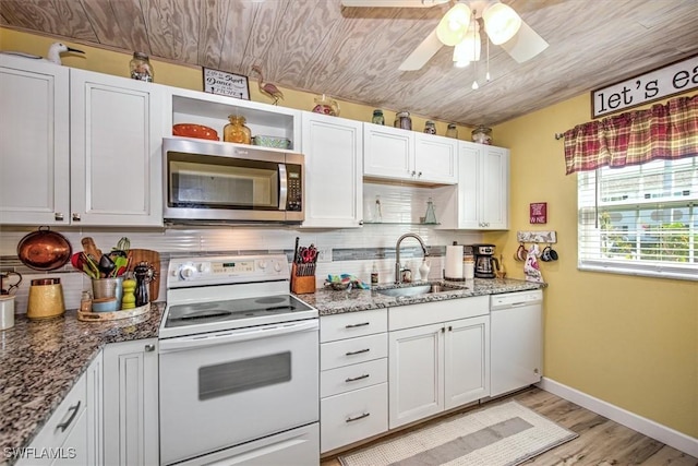 kitchen with stone counters, white appliances, a sink, white cabinetry, and open shelves