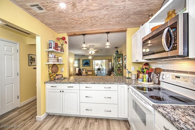 kitchen featuring white cabinets, stainless steel microwave, hanging light fixtures, white electric range, and open shelves