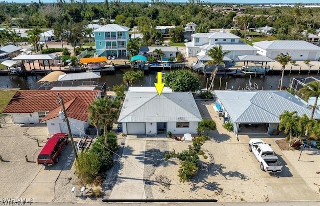 drone / aerial view featuring a residential view and a water view