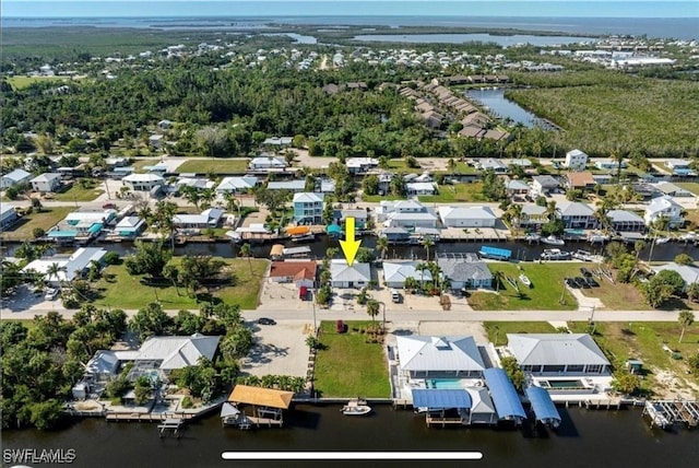 birds eye view of property with a residential view and a water view