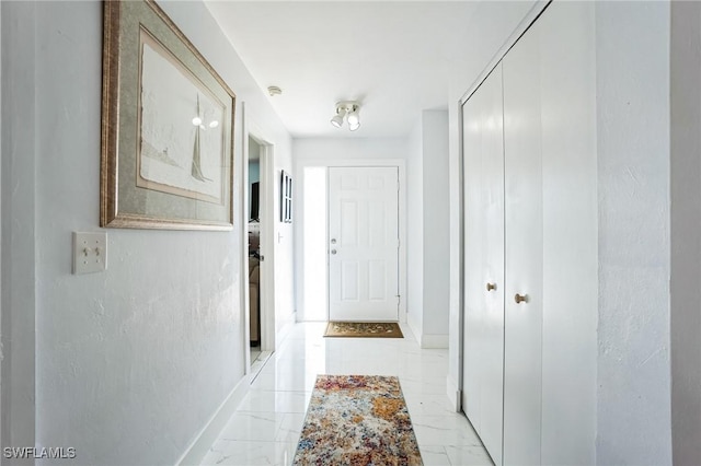 16221 Buccaneer St, Bokeelia, FL 33922 - hallway featuring marble finish floor and baseboards