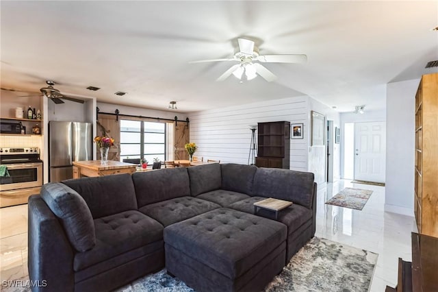 16221 Buccaneer St, Bokeelia, FL 33922 - living area featuring a ceiling fan, a barn door, and visible vents