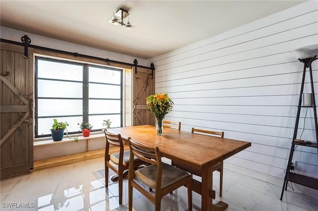 16221 Buccaneer St, Bokeelia, FL 33922 - dining space with a barn door and wooden walls