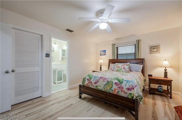 16221 Buccaneer St, Bokeelia, FL 33922 - bedroom with ensuite bathroom, visible vents, baseboards, ceiling fan, and wood finished floors
