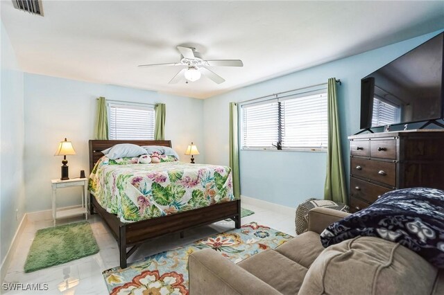 16221 Buccaneer St, Bokeelia, FL 33922 - bedroom featuring baseboards, multiple windows, ceiling fan, and visible vents