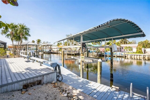 16221 Buccaneer St, Bokeelia, FL 33922 - view of dock with boat lift and a water view